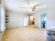 Open living room with a refrigerator, tile flooring, and easy access to the bathroom at 1107 Northshore Dr, Eustis, FL 32726