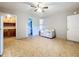 Inviting living room showcasing tile flooring, a ceiling fan, and a neutral-toned couch at 1107 Northshore Dr, Eustis, FL 32726