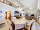 Bright living room with vaulted ceilings, a fireplace, and open concept design to the dining area at 1107 Northshore Dr, Eustis, FL 32726
