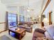 Spacious living room with large windows, vaulted ceilings, and an open floor plan at 1107 Northshore Dr, Eustis, FL 32726