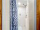 Shower features white tiles and a blue-patterned shower curtain at 1107 Northshore Dr, Eustis, FL 32726