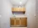 Functional sink area with neutral walls and convenient overhead cabinet storage at 1107 Northshore Dr, Eustis, FL 32726