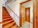 Staircase featuring hardwood steps and wood railing at 1107 Northshore Dr, Eustis, FL 32726
