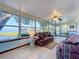 Bright sunroom with large windows providing beautiful water views and access to the outdoors at 1107 Northshore Dr, Eustis, FL 32726