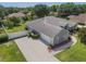 Aerial view of a well maintained home with a large driveway and fenced in backyard at 11437 Alameda Sandra Dr, Clermont, FL 34711
