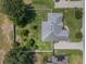 Birds eye view of home with large trees and well manicured lawn at 11437 Alameda Sandra Dr, Clermont, FL 34711