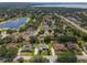 A tranquil lake view compliments this peaceful neighborhood, with mature tree coverage, and convenient road access at 11437 Alameda Sandra Dr, Clermont, FL 34711