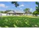 Expansive backyard with lush lawn and screened lanai offering privacy and outdoor enjoyment at 11437 Alameda Sandra Dr, Clermont, FL 34711