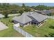 Backyard aerial view showcasing a lush lawn, privacy fence, and access to the screened in patio at 11437 Alameda Sandra Dr, Clermont, FL 34711