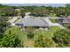 Backyard aerial view showcasing a lush lawn, privacy fence, and skylights at 11437 Alameda Sandra Dr, Clermont, FL 34711