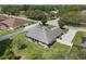 Backyard aerial view showcasing lush lawn, privacy fence, and access to the screened in patio at 11437 Alameda Sandra Dr, Clermont, FL 34711