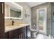 Modern bathroom with lighted mirror, stylish vanity, and walkout to patio at 11437 Alameda Sandra Dr, Clermont, FL 34711