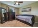 Cozy bedroom showcasing a daybed, dresser, and a decorative mirror at 11437 Alameda Sandra Dr, Clermont, FL 34711