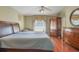 Comfortable bedroom with two beds, hardwood floors, ceiling fan, and plenty of storage space at 11437 Alameda Sandra Dr, Clermont, FL 34711