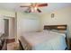 A comfortably furnished bedroom features a ceiling fan and a double closet at 11437 Alameda Sandra Dr, Clermont, FL 34711