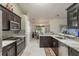 A stylish kitchen boasts granite counters, stainless steel appliances, and tile flooring at 11437 Alameda Sandra Dr, Clermont, FL 34711