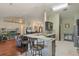 Open concept kitchen and living room featuring barstool seating and hardwood floors offer seamless entertaining at 11437 Alameda Sandra Dr, Clermont, FL 34711