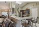 A kitchen featuring a bar, hardwood floors, modern appliances, and dark wood cabinets, perfect for cooking and entertaining at 11437 Alameda Sandra Dr, Clermont, FL 34711