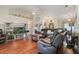 Spacious living room with hardwood floors, a ceiling fan, and a large sectional sofa creates a cozy gathering space at 11437 Alameda Sandra Dr, Clermont, FL 34711