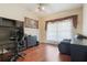 Office features hardwood floors, a ceiling fan, and natural light with space for a desk and storage at 11437 Alameda Sandra Dr, Clermont, FL 34711