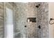 Contemporary shower features gray-toned tilework, built-in niche, and a sleek, modern design at 11437 Alameda Sandra Dr, Clermont, FL 34711