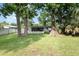 Lush backyard with green grass and large trees, offering a serene and private outdoor space at 121 Mason Park Dr, Daytona Beach, FL 32117