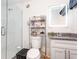 Cozy bathroom with granite countertop, lit mirror, and glass enclosed shower with subway tile at 121 Mason Park Dr, Daytona Beach, FL 32117