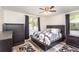 Cozy bedroom with stylish decor and dark wood furniture complemented by bright, natural light at 121 Mason Park Dr, Daytona Beach, FL 32117