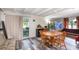 Bright dining room with wood floors, table with four chairs, and sliding glass doors to porch at 121 Mason Park Dr, Daytona Beach, FL 32117