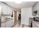 Well-designed kitchen featuring modern cabinets and a rustic sliding barn door to another room at 121 Mason Park Dr, Daytona Beach, FL 32117