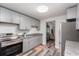 Modern kitchen with sleek cabinets, stainless steel appliances, and wood-look flooring at 121 Mason Park Dr, Daytona Beach, FL 32117
