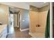 Bathroom featuring a tiled shower, wood-look tile flooring, and open access to other rooms at 1226 Overlook Rd, Eustis, FL 32726