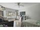 Bedroom with a ceiling fan, desk, flatscreen, and large window providing lots of natural light at 1226 Overlook Rd, Eustis, FL 32726