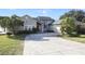 Charming home with a large driveway, gray siding, and well-maintained landscaping at 1226 Overlook Rd, Eustis, FL 32726