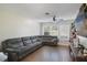 Spacious living room with tile floors, a ceiling fan, and a large gray sectional couch at 1226 Overlook Rd, Eustis, FL 32726