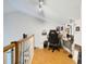 Loft space with hardwood floors, a desk area, and natural light from a window at 1226 Overlook Rd, Eustis, FL 32726
