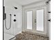 Modern walk-in shower with dual shower heads, white tile walls, and pebble flooring at 1226 Overlook Rd, Eustis, FL 32726