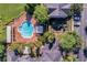 Aerial view of pool, playground, and parking, showcasing the community's amenities and layout from above at 130 Southern Pecan Cir # 204, Winter Garden, FL 34787