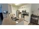 Well-lit kitchen with stainless steel appliances, granite countertops, and white cabinetry at 130 Southern Pecan Cir # 204, Winter Garden, FL 34787