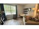 Living room with hardwood floors and large window providing plenty of natural light at 130 Southern Pecan Cir # 204, Winter Garden, FL 34787