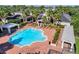 The community pool is surrounded by palm trees and lounge chairs, perfect for relaxation and recreation at 130 Southern Pecan Cir # 204, Winter Garden, FL 34787