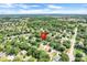 Aerial view of a charming neighborhood with homes nestled among lush trees, a serene and picturesque setting at 1311 Rain Forest Ln, Minneola, FL 34715