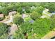 Overhead view of a neighborhood house surrounded by lush greenery at 1311 Rain Forest Ln, Minneola, FL 34715