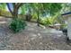 A leafy backyard with a gazebo area and a sloped, natural landscape at 1311 Rain Forest Ln, Minneola, FL 34715