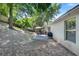 Backyard with a patio featuring a grill and a gazebo, surrounded by natural landscaping at 1311 Rain Forest Ln, Minneola, FL 34715