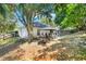 Charming home featuring a gazebo with outdoor seating and a fire pit in the spacious backyard at 1311 Rain Forest Ln, Minneola, FL 34715