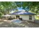 Expansive backyard with patio, grill, and outdoor seating area perfect for entertaining at 1311 Rain Forest Ln, Minneola, FL 34715