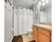 Neutral bathroom features a shower/tub combo with updated fixtures and a decorative mirror at 1311 Rain Forest Ln, Minneola, FL 34715