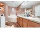 Large bathroom featuring a bathtub, double sinks, and a large mirror with lighting at 1311 Rain Forest Ln, Minneola, FL 34715