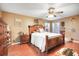 Spacious bedroom features a ceiling fan, hardwood floors, and a large wooden bed at 1311 Rain Forest Ln, Minneola, FL 34715